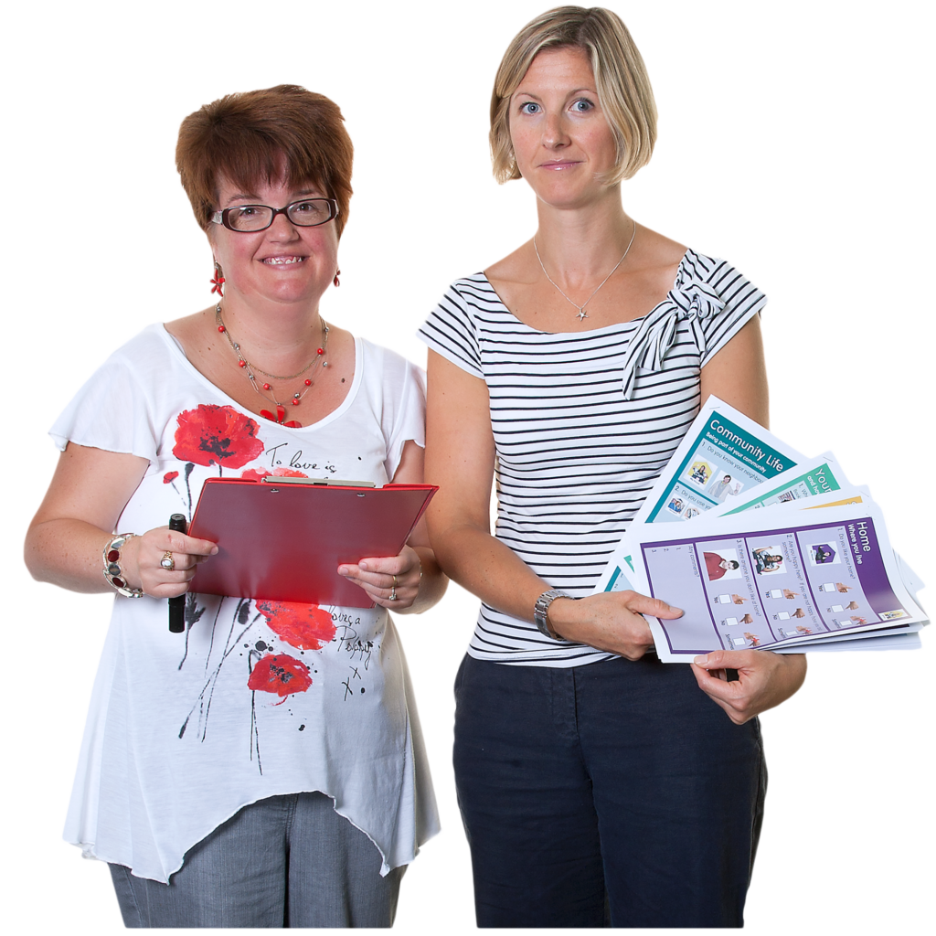 Two women holding booklets