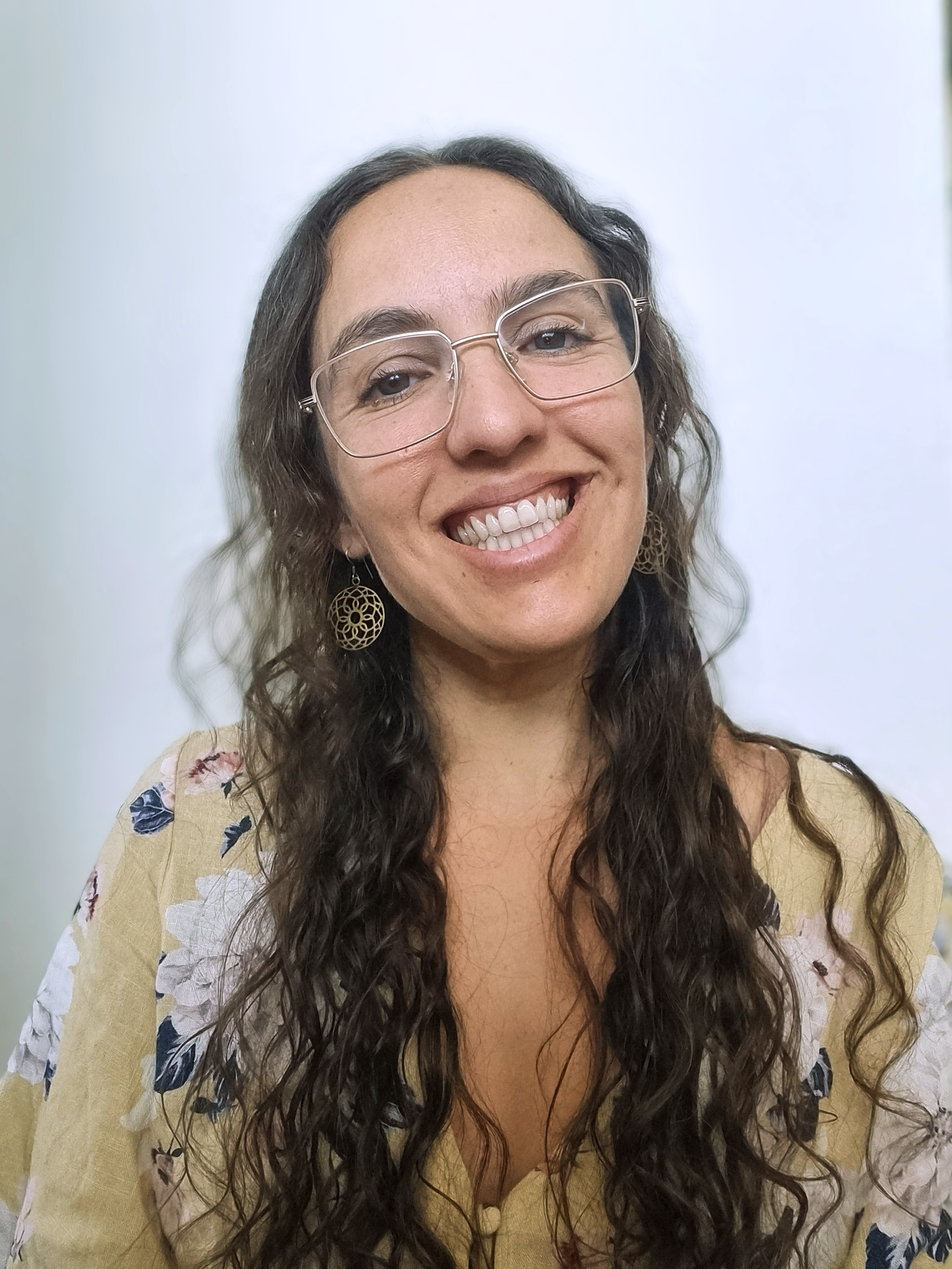 A woman with long brown hair wearing glasses
