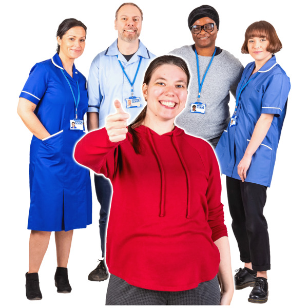 A smiling girl giving a thumbs-up with a group of healthcare workers behind her.
