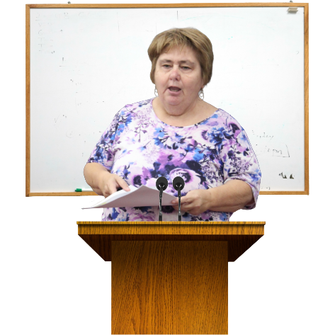 A woman on a podium speaking