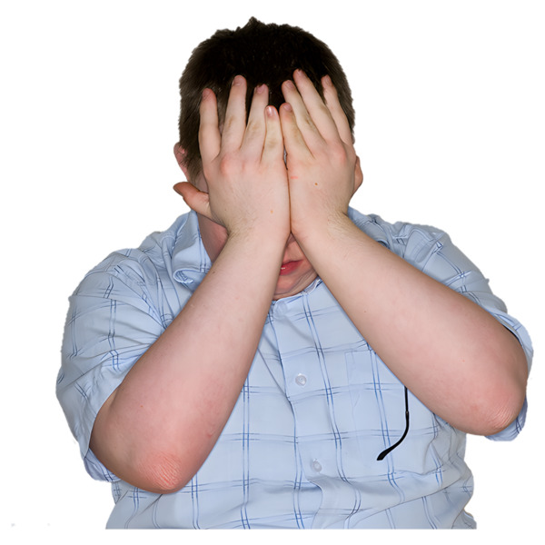 A man with his head down and his hands covering his face.