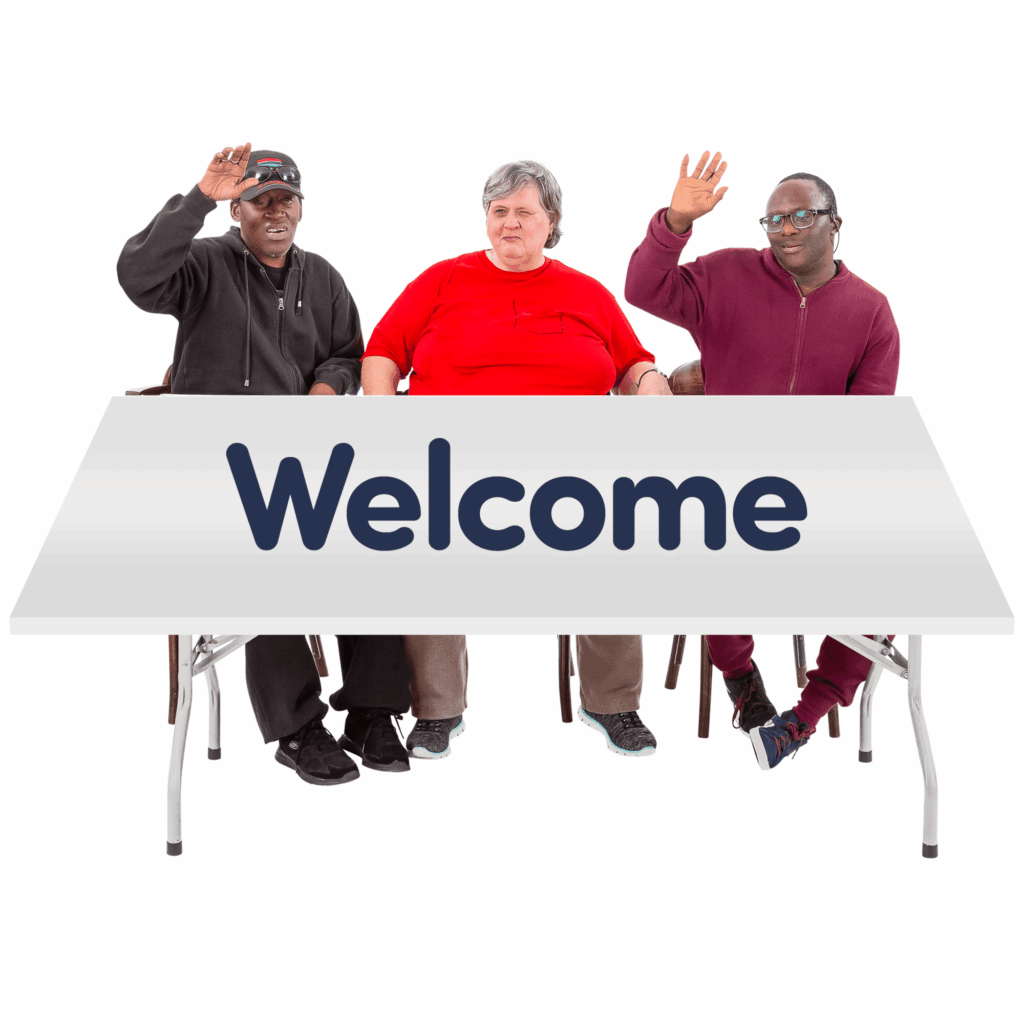 3 people sitting on a table with the word WELCOME