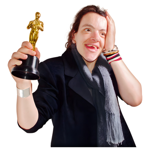 A smiling woman holding a gold trophy.