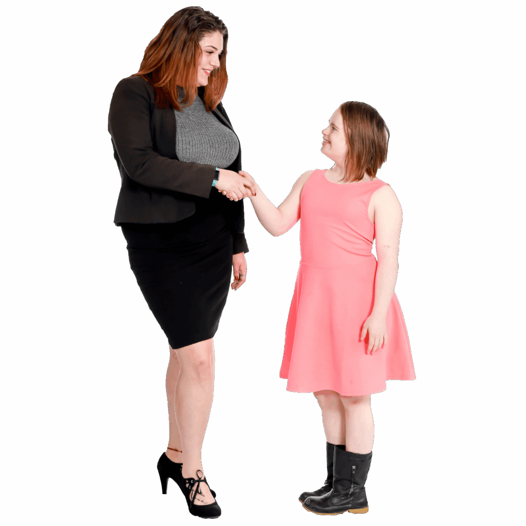 A tall woman shaking hands with a smaller woman