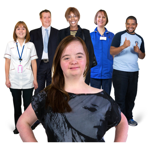 A smiling girl standing in front of a group of healthcare workers.