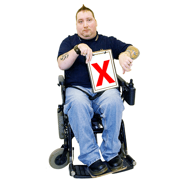 A man in a wheelchair holding a cross mark