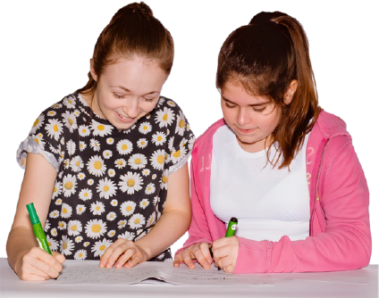 Two girls sitting side by side, writing on papers.